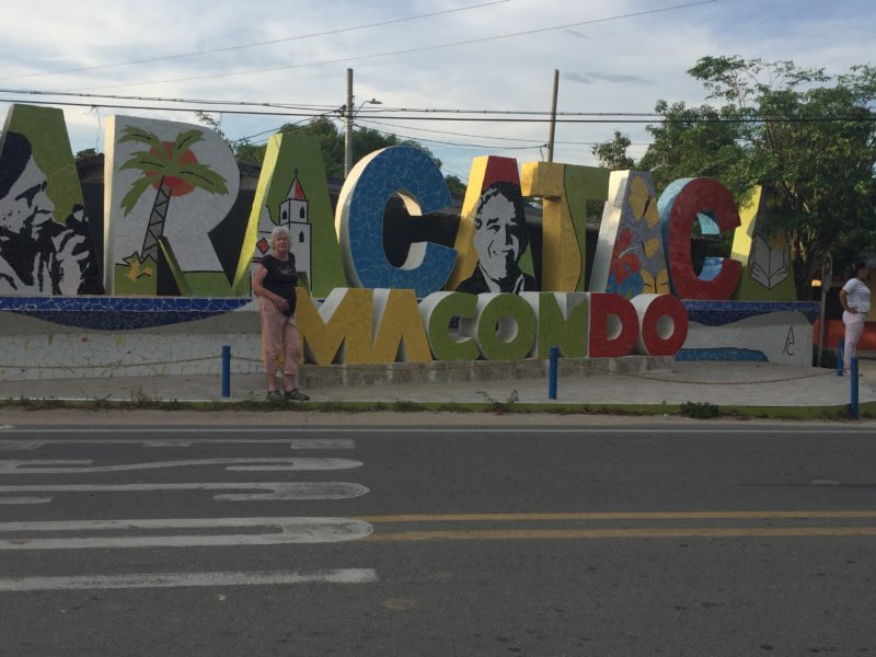 Author in front of old town sign