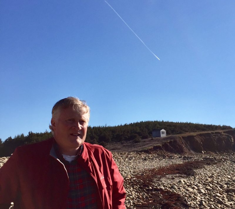 Gil MacLeod on beach below writer's shack