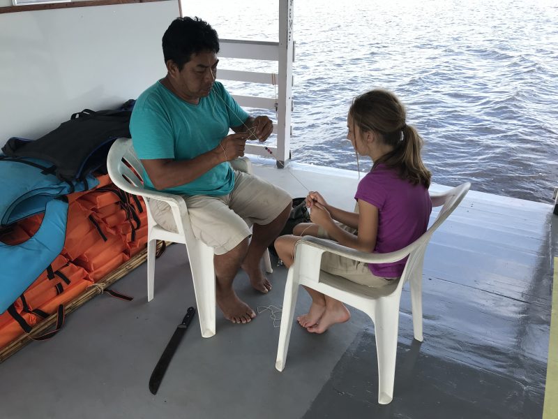 Sam weaving a traditional bracelet