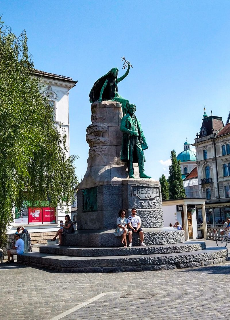People sitting by the Prešeren monument