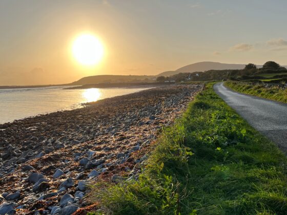 The sun rises over the Flaggy Shore on a day in late September 2023 in County Clare, Ireland.