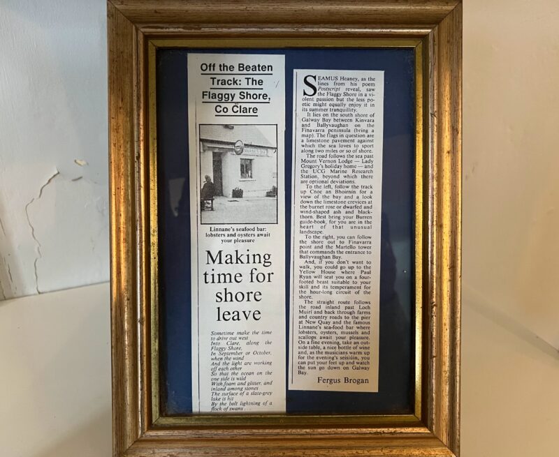 A framed clipping of an article about Seamus Heaney's poem "Postscript," from the Irish Times in 1996, in an Airbnb cottage in New Quay, Ireland.