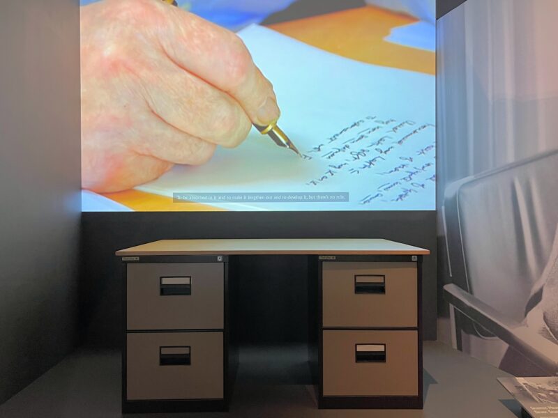 Seamus Heaney's desk, under a video projection, in the exhibit “Seamus Heaney: Listen Now Again” at the National Library of Ireland in Dublin. The exhibit runs through December 2025.